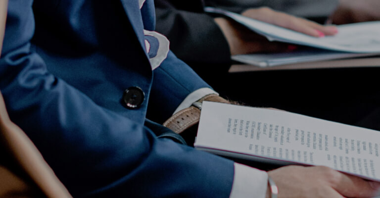 A group of people sitting in a conference room.